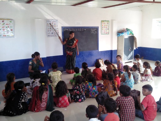 Teachers instructing students at the Happy School