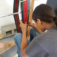 Student weaving in Hopi School weaving class