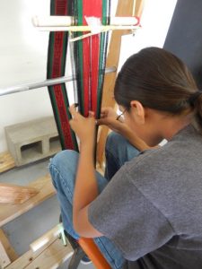 Student weaving in Hopi School weaving class